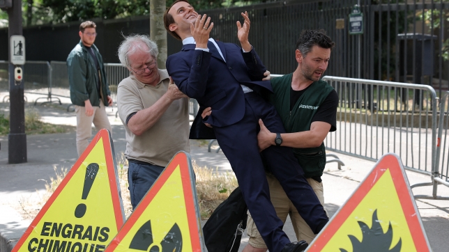 Les activistes de Greenpeace transportant la statue de cire du président français Emmanuel Macron