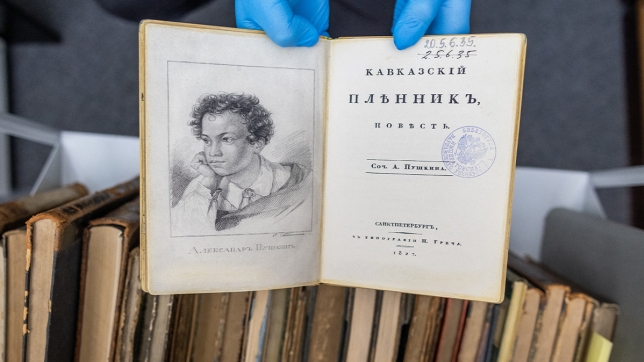 Un employé de l’université présente une fausse copie de la première édition du livre de 1822 «Kavkazskiy plennik : povest» d’Alexandre Pouchkine à la bibliothèque de l’université de Varsovie, à Varsovie, en Pologne, le 14 novembre 2023. Une vague de vols de classiques russes rares d’une valeur de plusieurs millions d’euros dans des bibliothèques d’Europe de l’Est a laissé une trace qui pointe jusqu’à Moscou.
