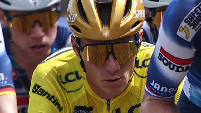 Soudal Quick-Step's Belgian rider Remco Evenepoel (C) wearing the overall leader's yellow jersey cycles with the pack during the 5th stage of the 77th edition of the Criterium du Dauphine cycling race, 183 km between Saint-Priest and MÃ¢con, on June 12, 2025. (Photo by Anne-Christine POUJOULAT / AFP)