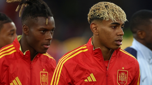 Spain's forward #19 Lamine Yamal (R) and Spain's forward #11 Nico Williams (L) walk on to the pitch prior to the UEFA Nations League semi-final football match between Spain and France in Stuttgart, southwestern Germany, on June 5, 2025. (Photo by FRANCK FIFE / AFP)