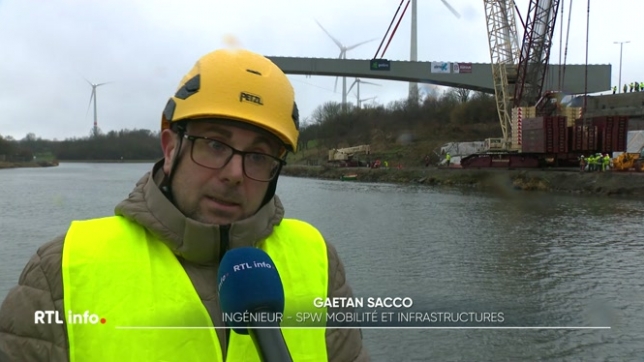 Une partie du pont sur l'autoroute E42 s'était effondrée il y a 11 mois, faisant un mort. La structure métallique du nouveau pont doit être installée, et l'opération est très minutieuse et impressionnante.