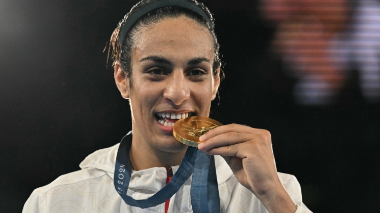 (FILES) Gold medallist Algeria's Imane Khelif poses on the podium during the medal ceremony for the women's 66kg final boxing category during the Paris 2024 Olympic Games at the Roland-Garros Stadium, in Paris on August 9, 2024. Algerian Olympic champion boxer Imane Khelif, who is at the centre of a row over gender eligibility, will not compete in this week's tournament in The Netherlands, organisers said on June 5, 2025. (Photo by MOHD RASFAN / AFP)
