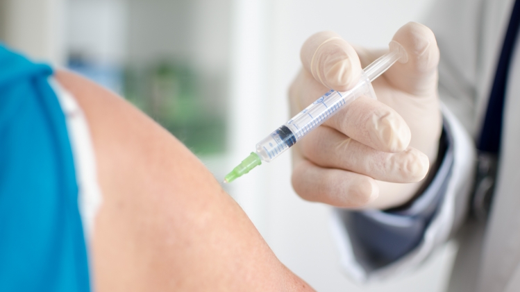 Doctor making an injection to a patient