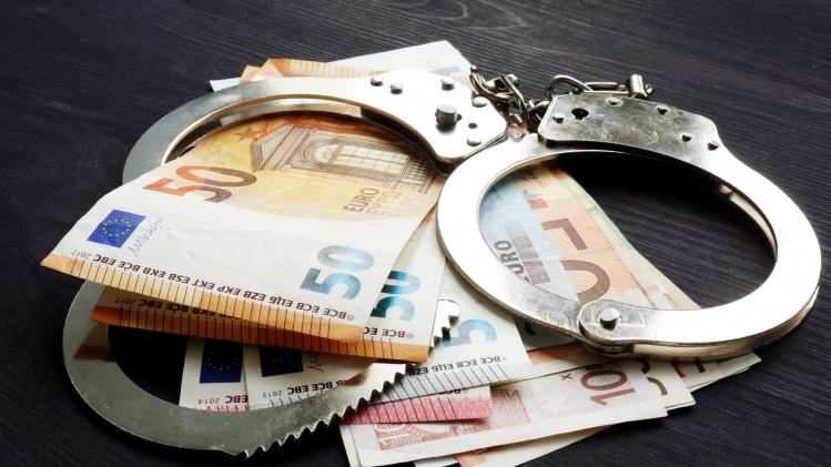 Handcuffs and euro banknotes. Penalty or fine in EU concept.