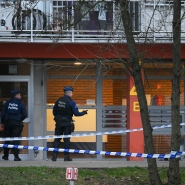 Police officers stand behind a police cordon at an investigation area at the « Cite du Peterbos » neighbourhood, where a man was killed overnight in a new shooting linked to drug trafficking in the municipality of Anderlecht, Brussels, on February 7, 2025. It is the third shooting since the morning of February 5 in Anderlecht, which has several known drug sales points – trafficking hotspots identified by the authorities. (Photo by NICOLAS TUCAT / AFP)