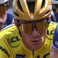 Soudal Quick-Step's Belgian rider Remco Evenepoel (C) wearing the overall leader's yellow jersey cycles with the pack during the 5th stage of the 77th edition of the Criterium du Dauphine cycling race, 183 km between Saint-Priest and MÃ¢con, on June 12, 2025. (Photo by Anne-Christine POUJOULAT / AFP)