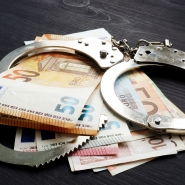 Handcuffs and euro banknotes. Penalty or fine in EU concept.